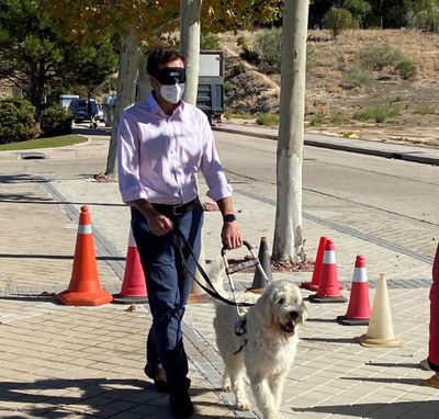Uno de los responsables de Royal Canin realizando un recorrido con antifaz y guiado por un futuro perro guía de la Fundación